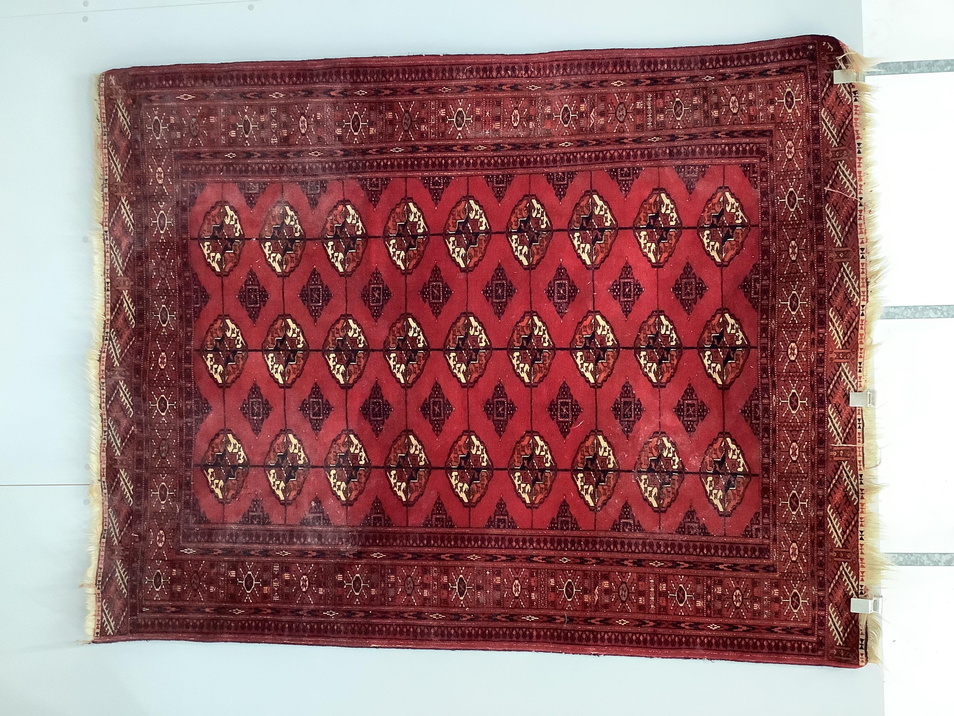 A Bokhara red ground rug, 183 x 145cm
